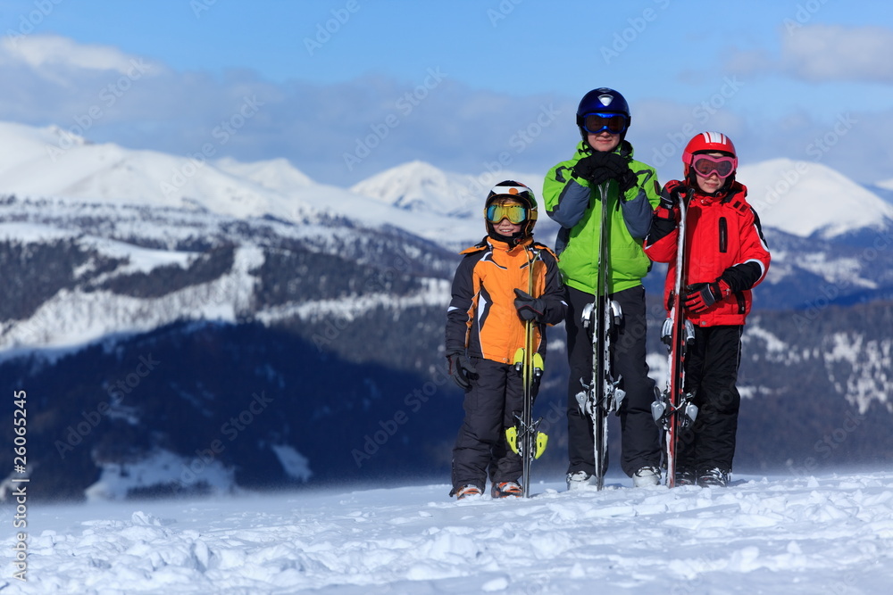 Children with skis on mountain