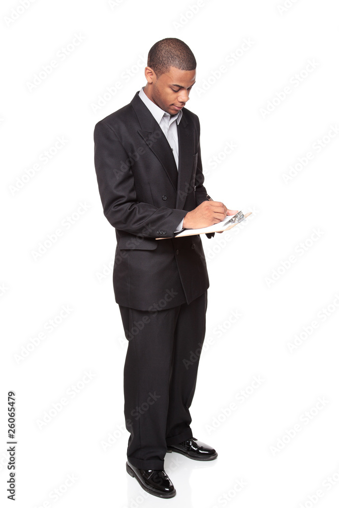 writing on clipboard - African American businessman writing on clipboard - African American businessman