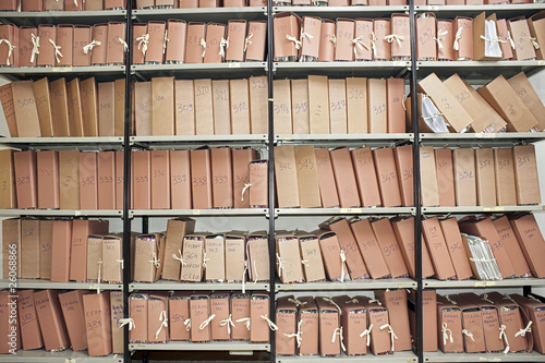 Office archive with many folders on metal shelves