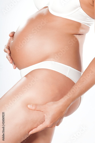 Pregnant woman pinching cellulite © snaptitude