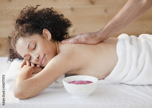 Mixed race woman receiving massage