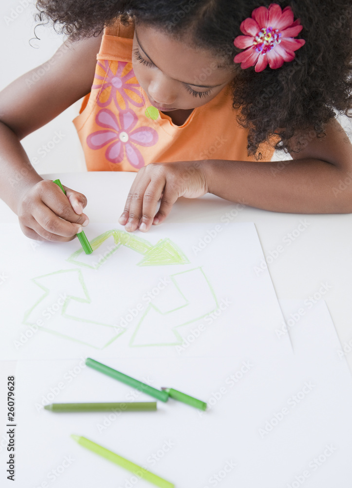 Mixed race girl drawing recycling symbol with crayons Mixed race girl drawing recycling symbol with crayons