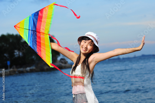 Asian Girl with kite under the sun