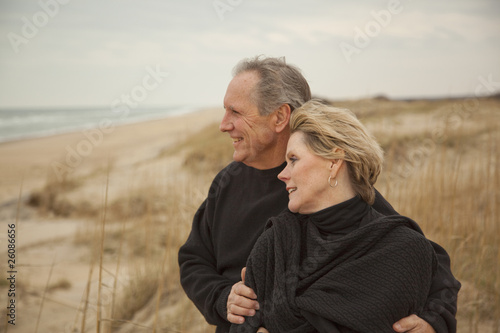 Caucasian couple standing on beach photo