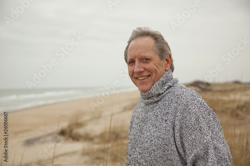 Caucasian man standing on beach photo