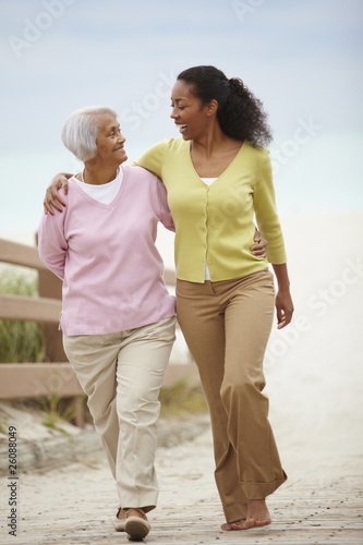 African American woman walking with mother photo