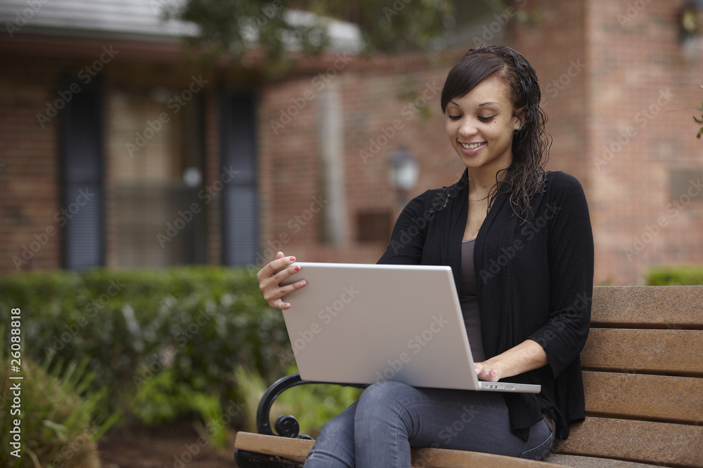 Mixed race woman typing on laptop Mixed race woman typing on laptop