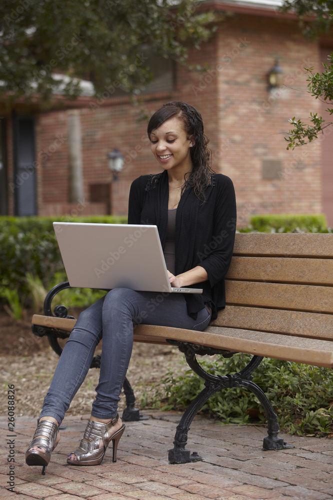 Mixed race woman typing on laptop Mixed race woman typing on laptop