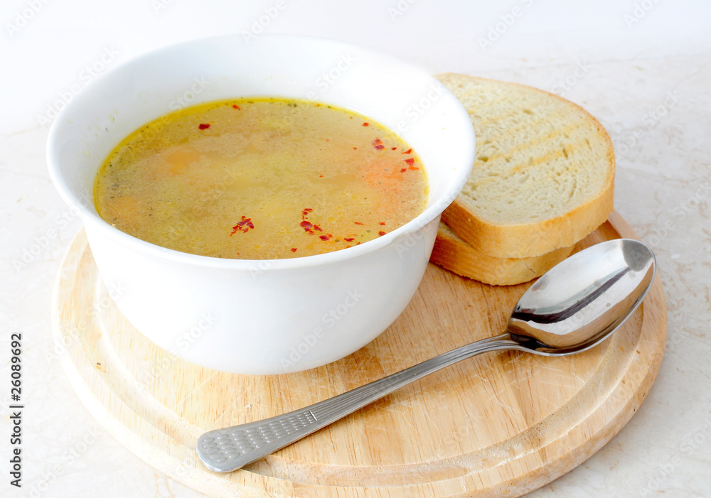 Vegetable / chicken soup with bread and spoon Vegetable / chicken soup with bread and spoon