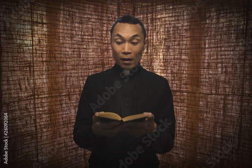 Pacific Islander priest reading bible photo