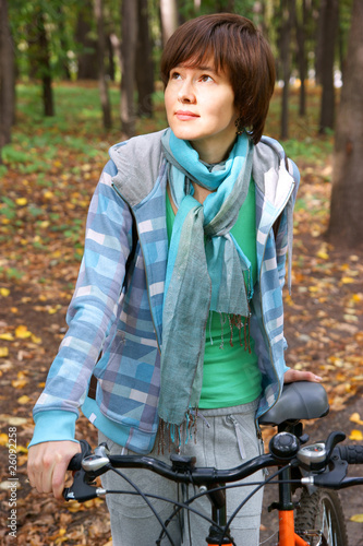 Woman with bicycle in autumn park