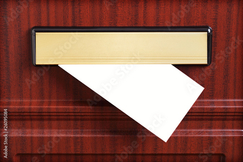 Foto Blank envelope through mail slot