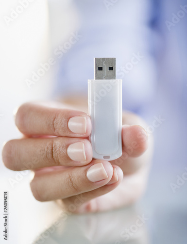 Hand holding USB stick photo