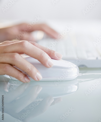 Hands operating computer mouse and keyboard photo