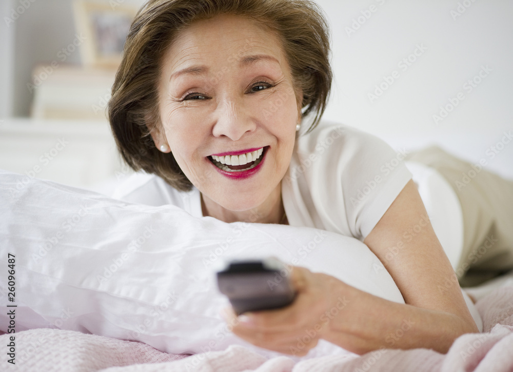 Japanese woman watching television in bed Japanese woman watching television in bed