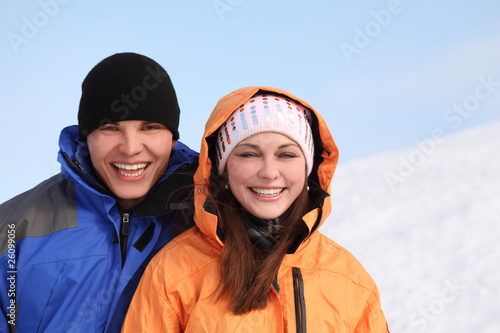 man and girl in sport clothes standing and smiling