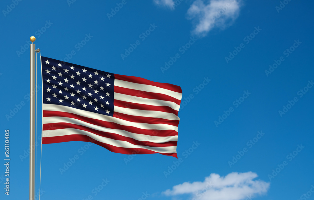 Flag of the USA waving in the wind in front of blue sky