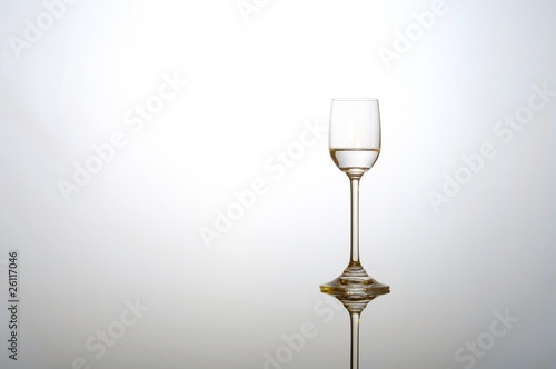 Fototapeta Liqour glass with golden reflections