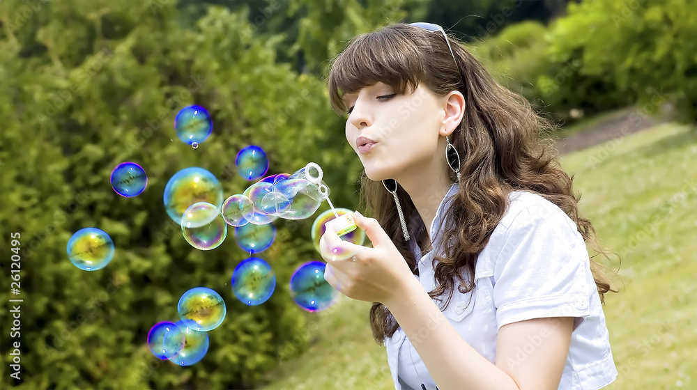 Young girl blowing soap bubbles in autumn park Young girl blowing soap bubbles in autumn park