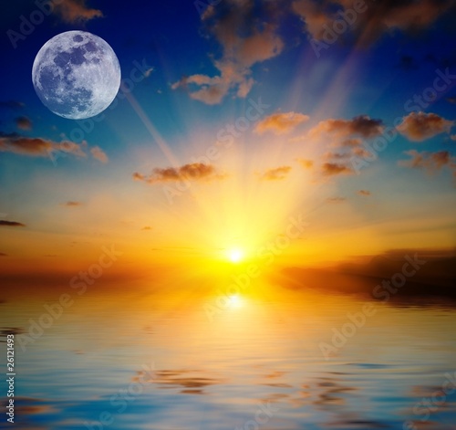 full moon by a majestic sunset above a lake