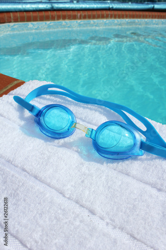 swiimng goggles on a poolside