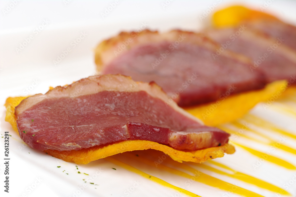 A slice of duck meat on sweet potato chip (Selective Focus) A slice of duck meat on sweet potato chip (Selective Focus)
