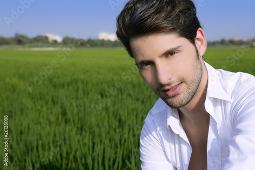 Young man outdoor happy in green meadow