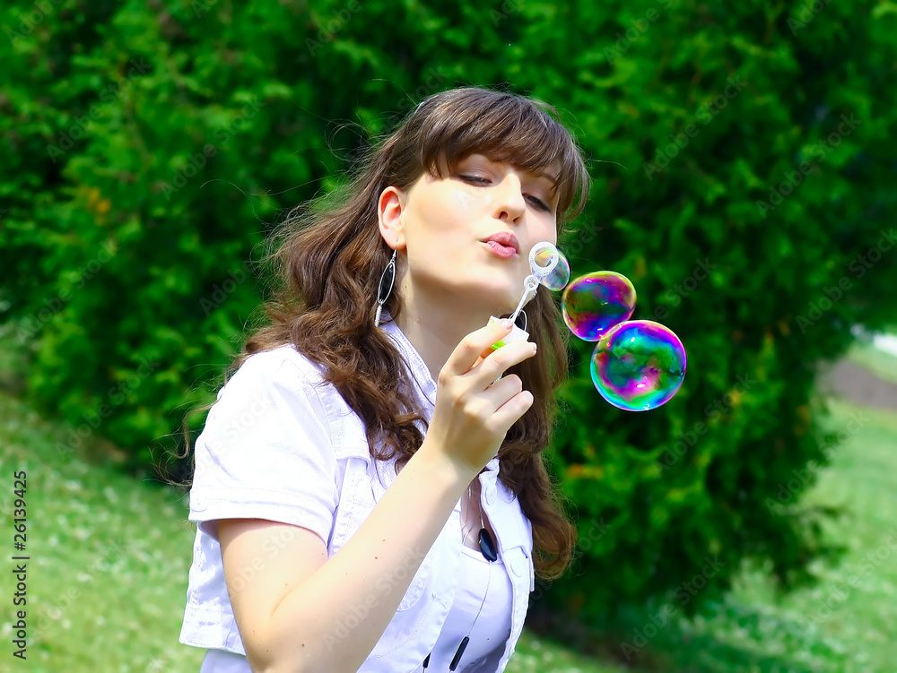 Young girl blowing soap bubbles in autumn park Young girl blowing soap bubbles in autumn park