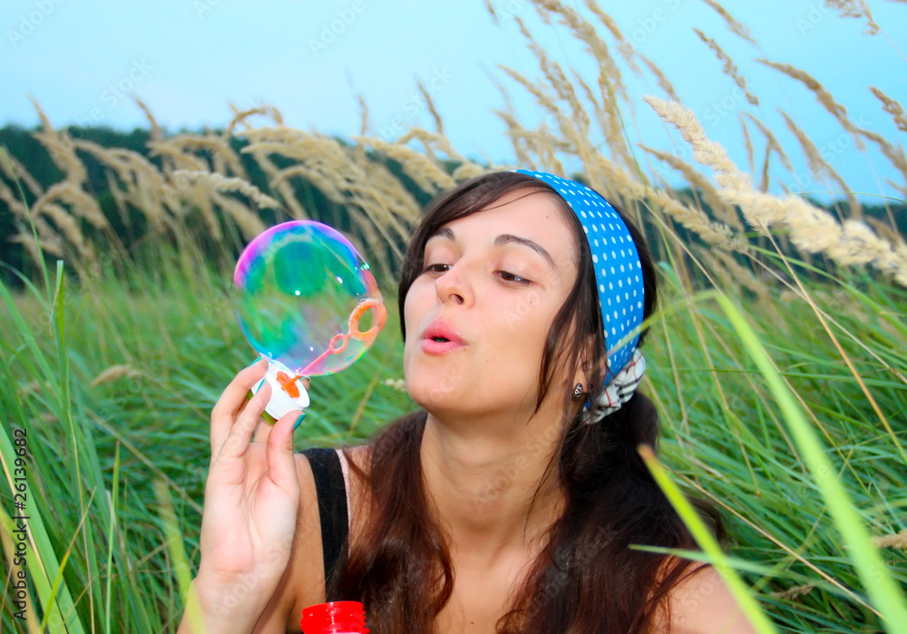 Young girl blowing soap bubbles in autumn park Young girl blowing soap bubbles in autumn park