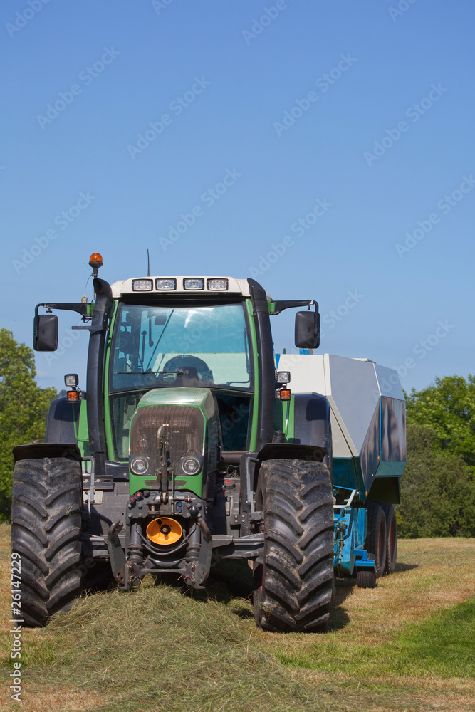 Obraz premium Tractor with a hay baler