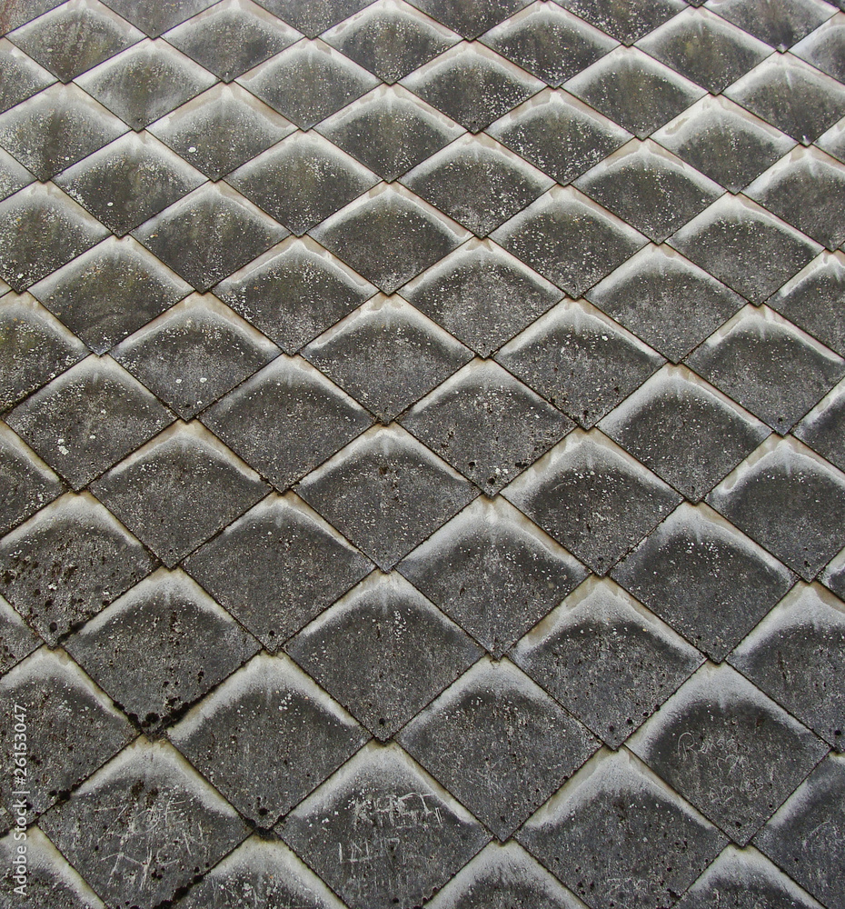 side shot of house showing scales attached to a wall with spurs