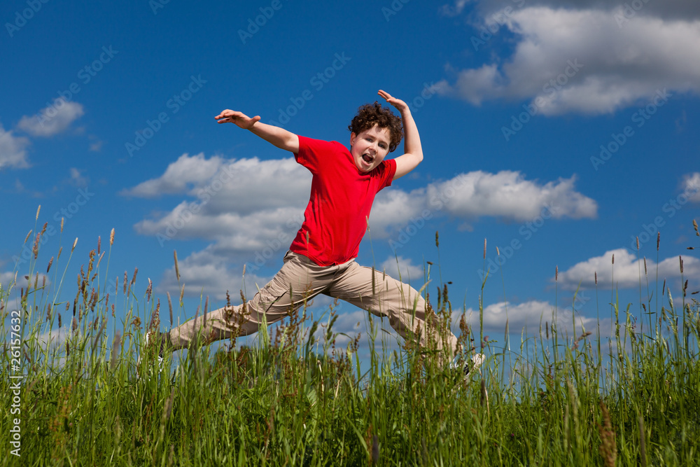 Boy jumping, running against blue sky Boy jumping, running against blue sky