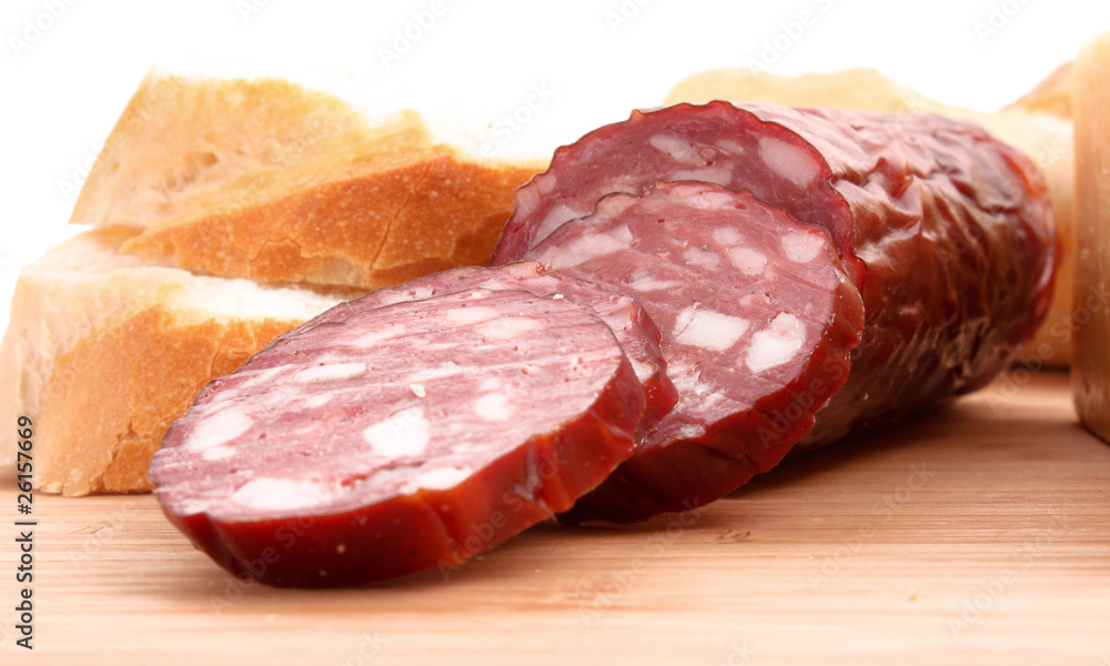 Sausage and bread on wooden surface Sausage and bread on wooden surface