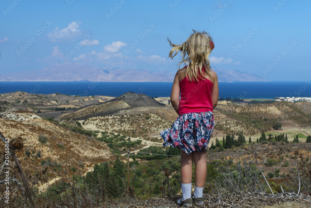 girl looks at the beautiful sea, beach and mountains in Greece girl looks at the beautiful sea, beach and mountains in Greece
