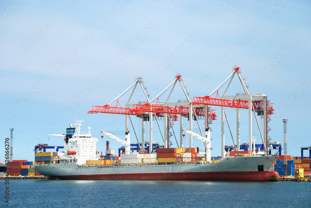 The trading seaport with cranes, cargoes and ship