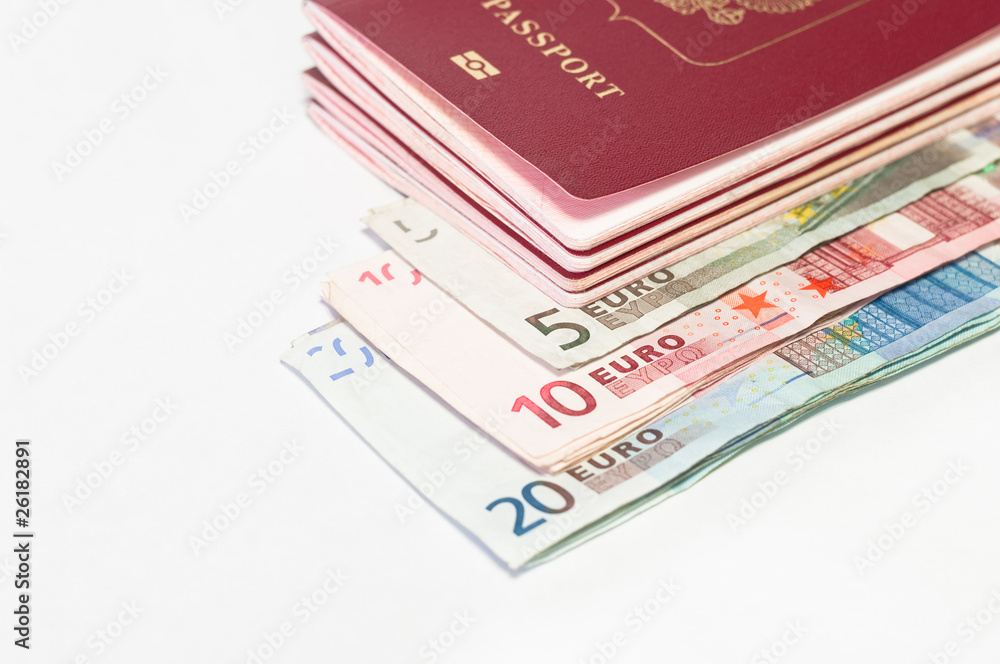 Pile of red passports and euro cash small banknotes on white Pile of red passports and euro cash small banknotes on white