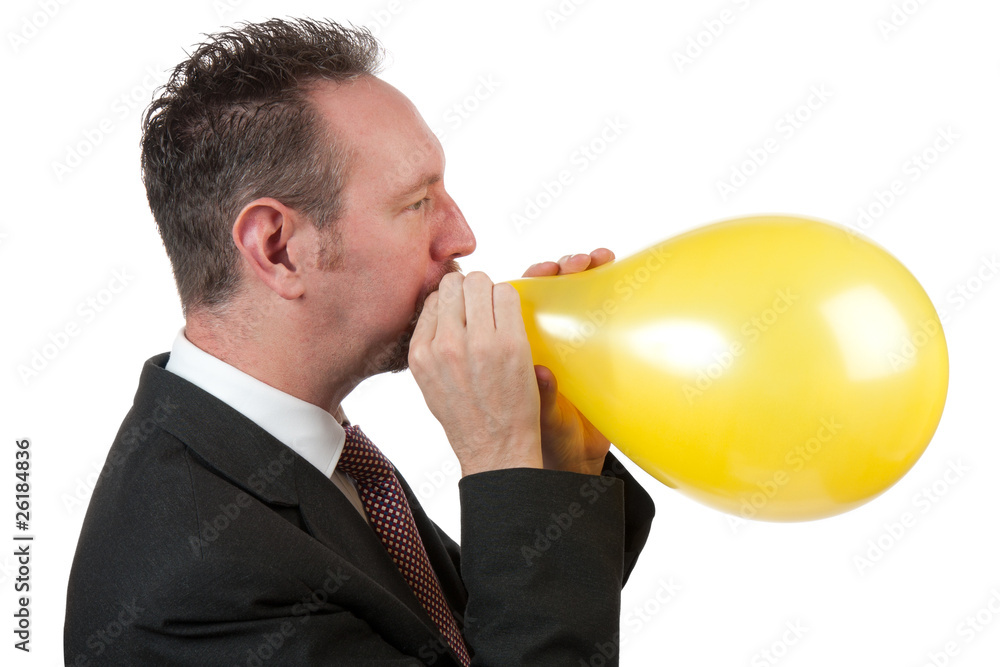 Side On Businessman Blowing Up a Balloon Side On Businessman Blowing Up a Balloon