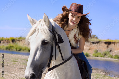 young cowgirl on white horse smile © yuriyzhuravov