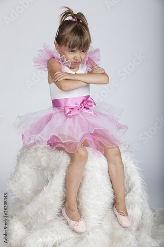 Little brat ballerina holding her arms crossed