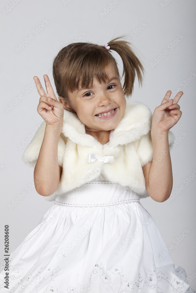 Little girl gesturing two fingers up, symbol for victory Little girl gesturing two fingers up, symbol for victory