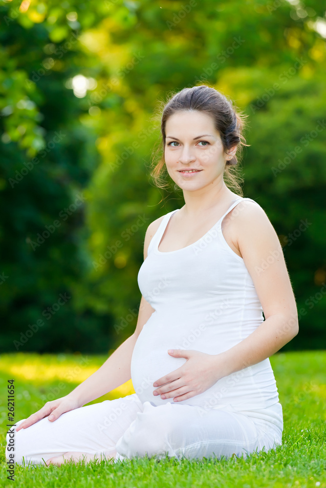 Beautiful pregnant woman relaxing in the park Beautiful pregnant woman relaxing in the park