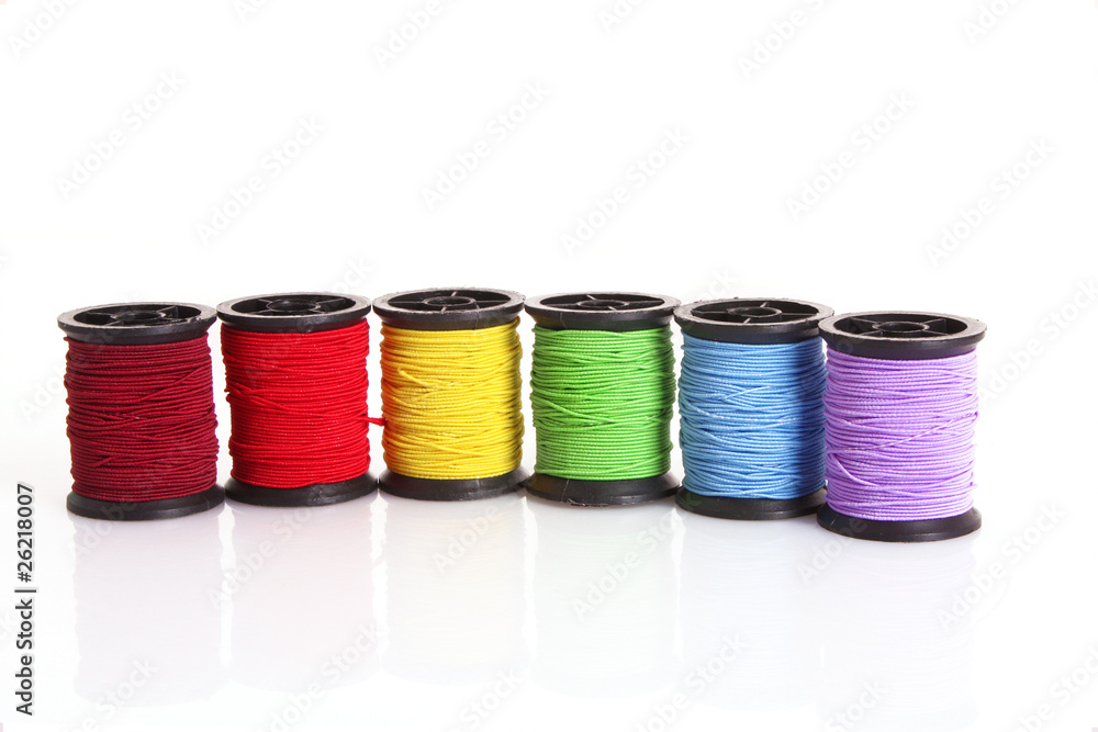 Coloured bobbins of thread isolated on white Coloured bobbins of thread isolated on white