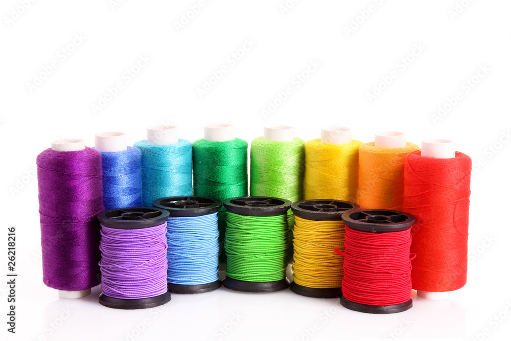 Coloured bobbins of thread isolated on white Coloured bobbins of thread isolated on white