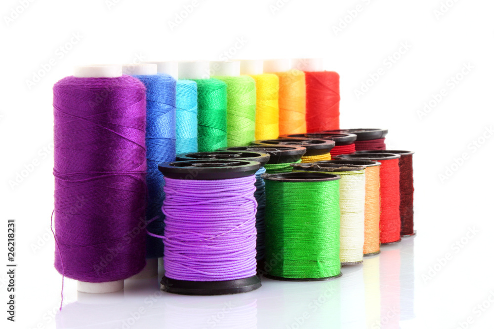 Coloured bobbins of thread isolated on white Coloured bobbins of thread isolated on white