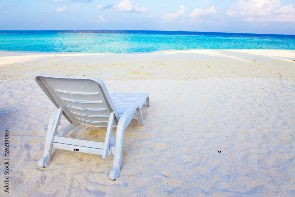Empty chaise lounge before ocean Empty chaise lounge before ocean