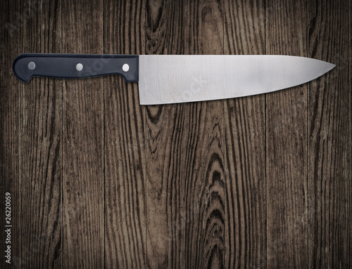 Kitchen knife on wooden table.