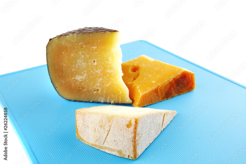 aged cheeses on blue plastic plate