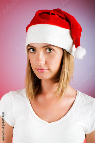 Girl with santa hat against gradient background photo