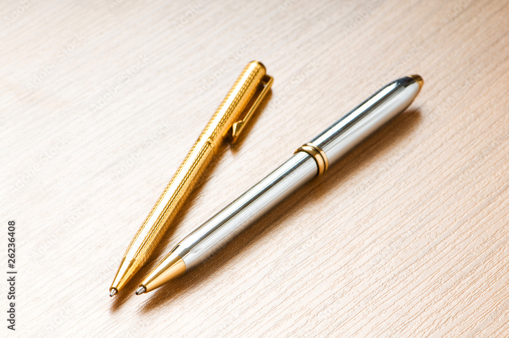 Writing silver pen on the wooden background Writing silver pen on the wooden background