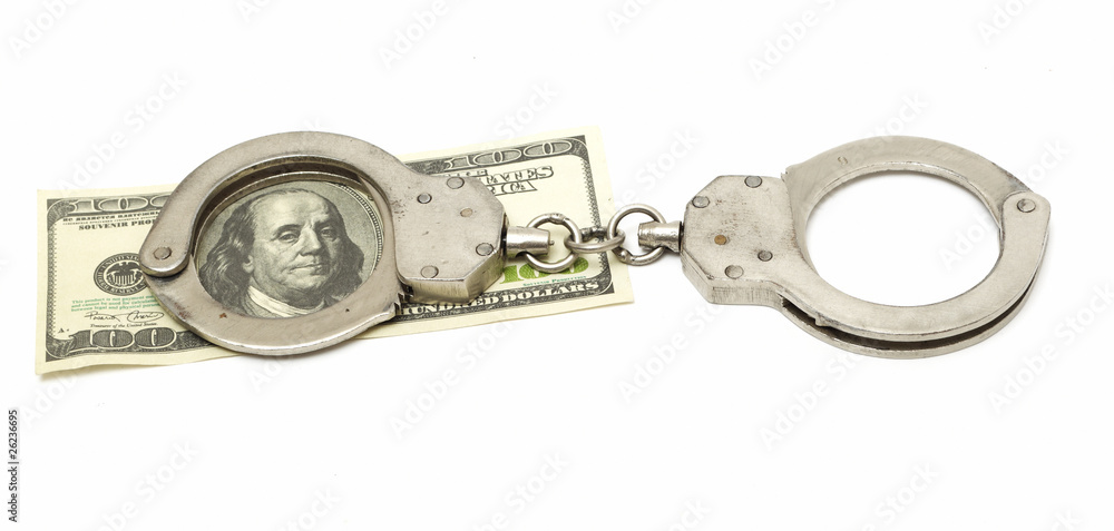 handcuffs with 100 dollar banknote isolated on white handcuffs with 100 dollar banknote isolated on white
